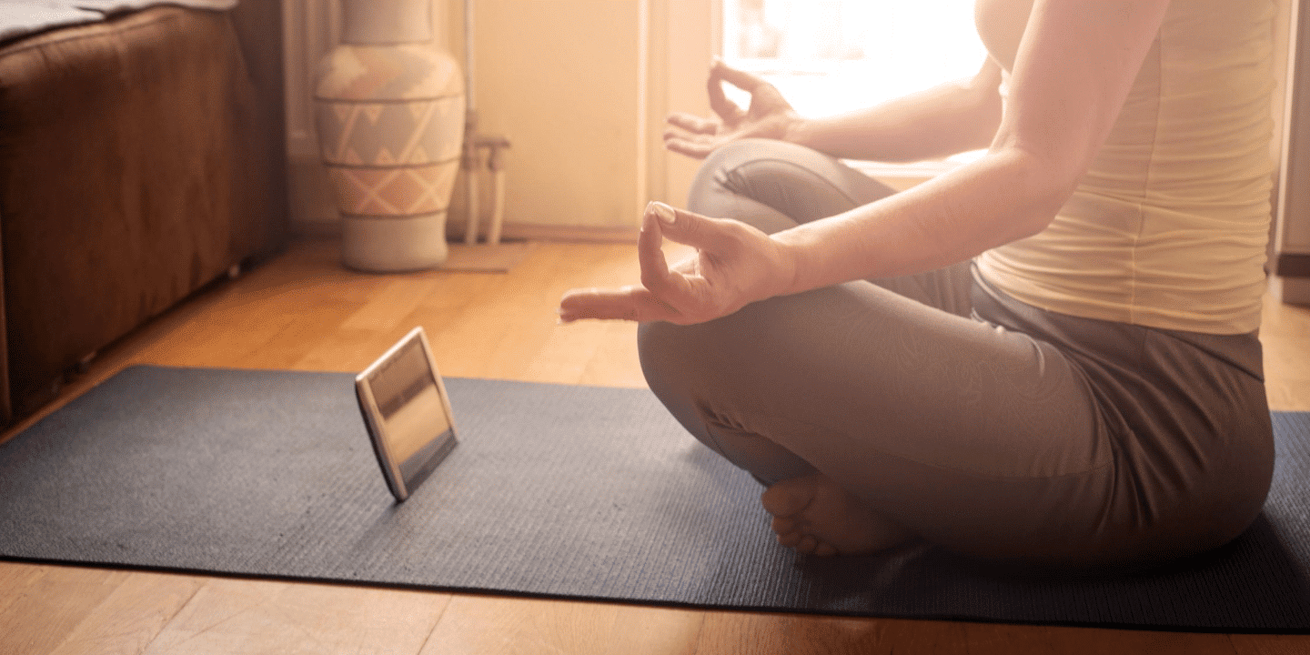 A woman listening to a free meditation on her tablet