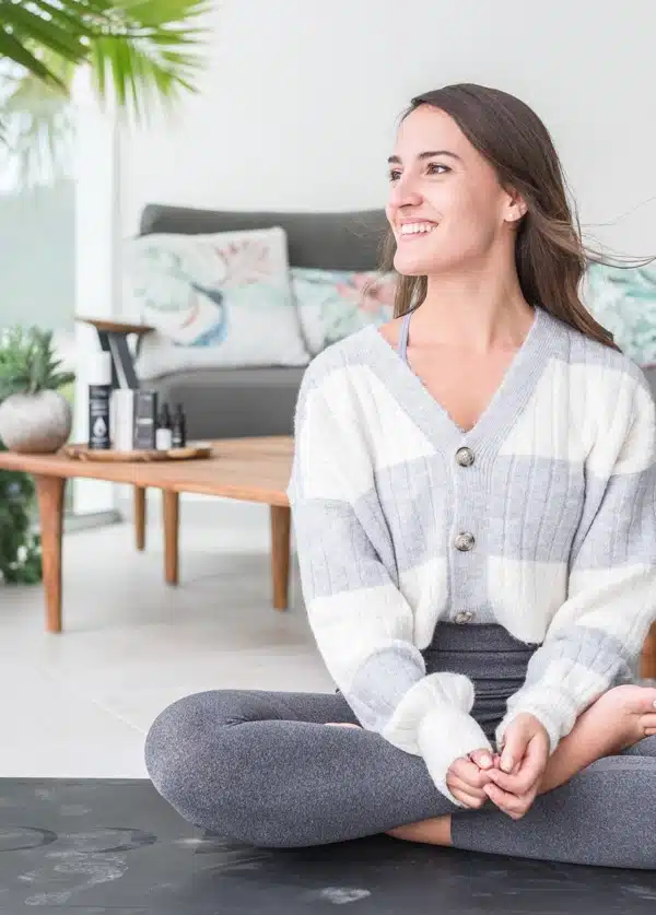 a young yoga enthusiast smiling after using CBD oil