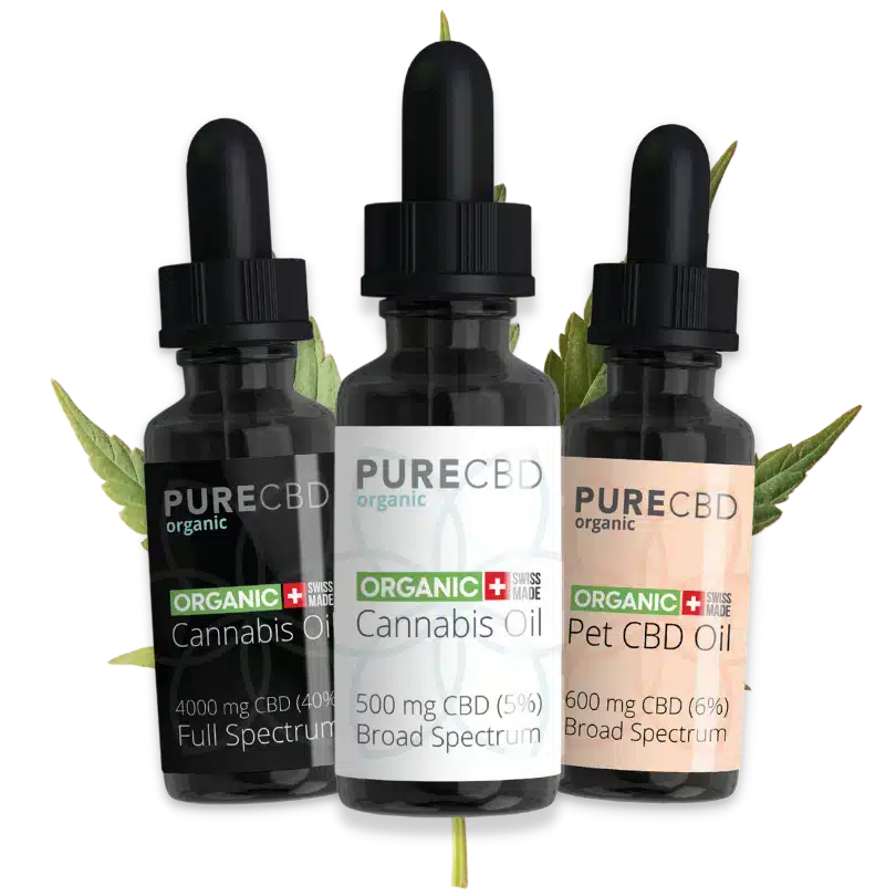 3 bottles of organic cbd oil in front of a cannabis leaf.